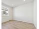 Well-lit bedroom with neutral tones and a large window providing plenty of natural light at 4046 N Irvington St, Aurora, CO 80019
