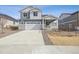 Charming two-story home featuring a covered porch, concrete driveway, and two car garage at 4046 N Irvington St, Aurora, CO 80019