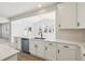 Kitchen with white cabinets and light countertops, with a view into the adjacent dining room at 4046 N Irvington St, Aurora, CO 80019