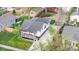 Aerial view of craftsman style home showcasing front porch, well-manicured lawn, and long driveway leading to a detached garage at 1960 S Franklin St, Denver, CO 80210