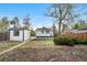 Backyard featuring a detached garage and mature trees, with ample space for outdoor activities at 1960 S Franklin St, Denver, CO 80210