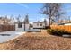 Large backyard with a detached garage and mature trees in a residential area at 1960 S Franklin St, Denver, CO 80210