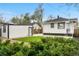 Backyard featuring a detached garage and lush greenery, with a privacy fence at 1960 S Franklin St, Denver, CO 80210