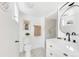 Modern bathroom with white fixtures, marble-look tile, and a walk-in shower offers a clean and stylish design at 1960 S Franklin St, Denver, CO 80210