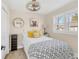 Cozy bedroom with neutral walls, a ceiling fan, and a black and white patterned bedspread at 1960 S Franklin St, Denver, CO 80210