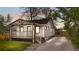 Charming home with a covered front porch, and a long driveway leading to a detached garage at 1960 S Franklin St, Denver, CO 80210