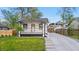 Charming home with a covered front porch, with well maintained lawn and landscaping at 1960 S Franklin St, Denver, CO 80210