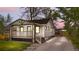 Charming bungalow with a covered porch and a well-maintained lawn and private driveway at 1960 S Franklin St, Denver, CO 80210
