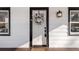 Elegant white front door with a decorative wreath, black hardware, and sidelight window create a welcoming entrance at 1960 S Franklin St, Denver, CO 80210