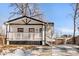 Charming home featuring a welcoming porch with a white railing and classic black and white exterior paint scheme at 1960 S Franklin St, Denver, CO 80210