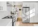 Bright white kitchen featuring stainless steel appliances, modern cabinetry, and countertops for a sleek, clean design at 1960 S Franklin St, Denver, CO 80210