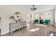 Bright living room featuring hardwood floors, neutral walls, and an ornate gray console under a decorative mirror at 1960 S Franklin St, Denver, CO 80210
