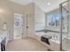 Well-appointed bathroom with a soaking tub, shower, and a view through the window at 16361 Parkside Dr, Parker, CO 80134