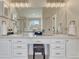 Well-lit bathroom showcasing double sinks, vanity area, and ample storage space at 16361 Parkside Dr, Parker, CO 80134