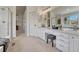Bright bathroom featuring dual vanities, a walk-in shower, and a glimpse of the soaking tub at 16361 Parkside Dr, Parker, CO 80134