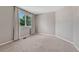 Empty bedroom with neutral-colored walls, carpet and a window with a view of greenery at 16361 Parkside Dr, Parker, CO 80134