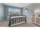 Cozy bedroom featuring a wrought iron bed frame and a window for natural light at 16361 Parkside Dr, Parker, CO 80134