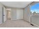 Bedroom featuring neutral walls and carpets with a window and closet with white doors at 16361 Parkside Dr, Parker, CO 80134