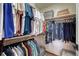 Organized closet featuring wooden rods, multiple clothing racks, and shelving for storage at 16361 Parkside Dr, Parker, CO 80134