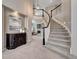 Elegant foyer featuring a curved staircase with white railings, dark accents, and stylish decor at 16361 Parkside Dr, Parker, CO 80134
