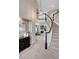Inviting foyer features a curved staircase, elegant light fixture, and entry into a cozy living room with fireplace at 16361 Parkside Dr, Parker, CO 80134