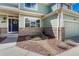 Inviting front entrance with a blue door, brick accents, and landscaped walkway, enhancing curb appeal at 16361 Parkside Dr, Parker, CO 80134
