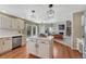 Open concept kitchen with center island, stainless appliances, and view to living area at 16361 Parkside Dr, Parker, CO 80134