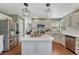 Well-appointed kitchen with island, stainless steel appliances, and wood floors at 16361 Parkside Dr, Parker, CO 80134