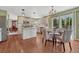 Open kitchen features an island, white cabinets, eat-in dining and stainless steel appliances at 16361 Parkside Dr, Parker, CO 80134