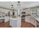 Modern kitchen featuring white cabinets, stainless steel appliances, hardwood floors, and a central island at 16361 Parkside Dr, Parker, CO 80134