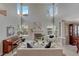 Spacious living room featuring tall windows, a fireplace, stylish furnishings, and a piano at 16361 Parkside Dr, Parker, CO 80134