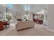 Open-concept living room with tall windows, a fireplace, piano, and seamless access to the dining area at 16361 Parkside Dr, Parker, CO 80134