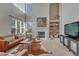 Bright living room with a fireplace, built-in shelving, and a large window at 16361 Parkside Dr, Parker, CO 80134