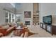 Bright living room with a fireplace, built-in shelving, and large windows at 16361 Parkside Dr, Parker, CO 80134