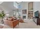 Spacious living room with vaulted ceilings, fireplace, built-ins, and large windows at 16361 Parkside Dr, Parker, CO 80134