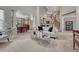 Spacious living room with staircase, view to dining room, and neutral finishes at 16361 Parkside Dr, Parker, CO 80134