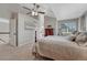 Another view of the spacious main bedroom with a vaulted ceiling and neutral decor at 16361 Parkside Dr, Parker, CO 80134
