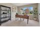 Home office features a large window, modern desk, and stylish shelving at 16361 Parkside Dr, Parker, CO 80134