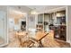 Charming dining area adjacent to the kitchen with a rustic table and a view into the living room at 963 N Logan St # 11, Denver, CO 80203