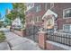 Brick apartment building with brick and metal gated fence surrounding the front entrance at 963 N Logan St # 11, Denver, CO 80203
