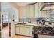 Updated kitchen featuring a stainless steel gas range, sleek countertops, and modern backsplash at 963 N Logan St # 11, Denver, CO 80203