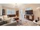 Comfortable living room with modern furnishings, a large TV, and bright natural light at 963 N Logan St # 11, Denver, CO 80203