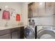 Convenient laundry room with modern washer and dryer, ample counter space, and stylish cabinetry at 14152 Bunny Hop Ln, Parker, CO 80134
