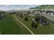 An aerial view showcases modern homes with sleek designs integrated within a serene landscape and golf course at 11160 Dolce Vita Pl, Littleton, CO 80125