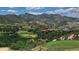Picturesque golf course community nestled against a stunning mountain backdrop with lush green fairways and luxurious homes at 11160 Dolce Vita Pl, Littleton, CO 80125