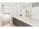 Double vanity bathroom with modern cabinetry and a view into bedroom at 3485 S Clermont St, Denver, CO 80222