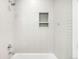 Clean bathroom with a shower/tub combo and white tile at 3485 S Clermont St, Denver, CO 80222