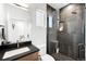 Contemporary bathroom with dark tile shower and floating vanity at 3485 S Clermont St, Denver, CO 80222