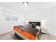 Cozy bedroom with orange and gray bedding and small side table at 3485 S Clermont St, Denver, CO 80222