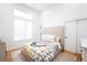 Well lit bedroom with beige headboard and large window at 3485 S Clermont St, Denver, CO 80222